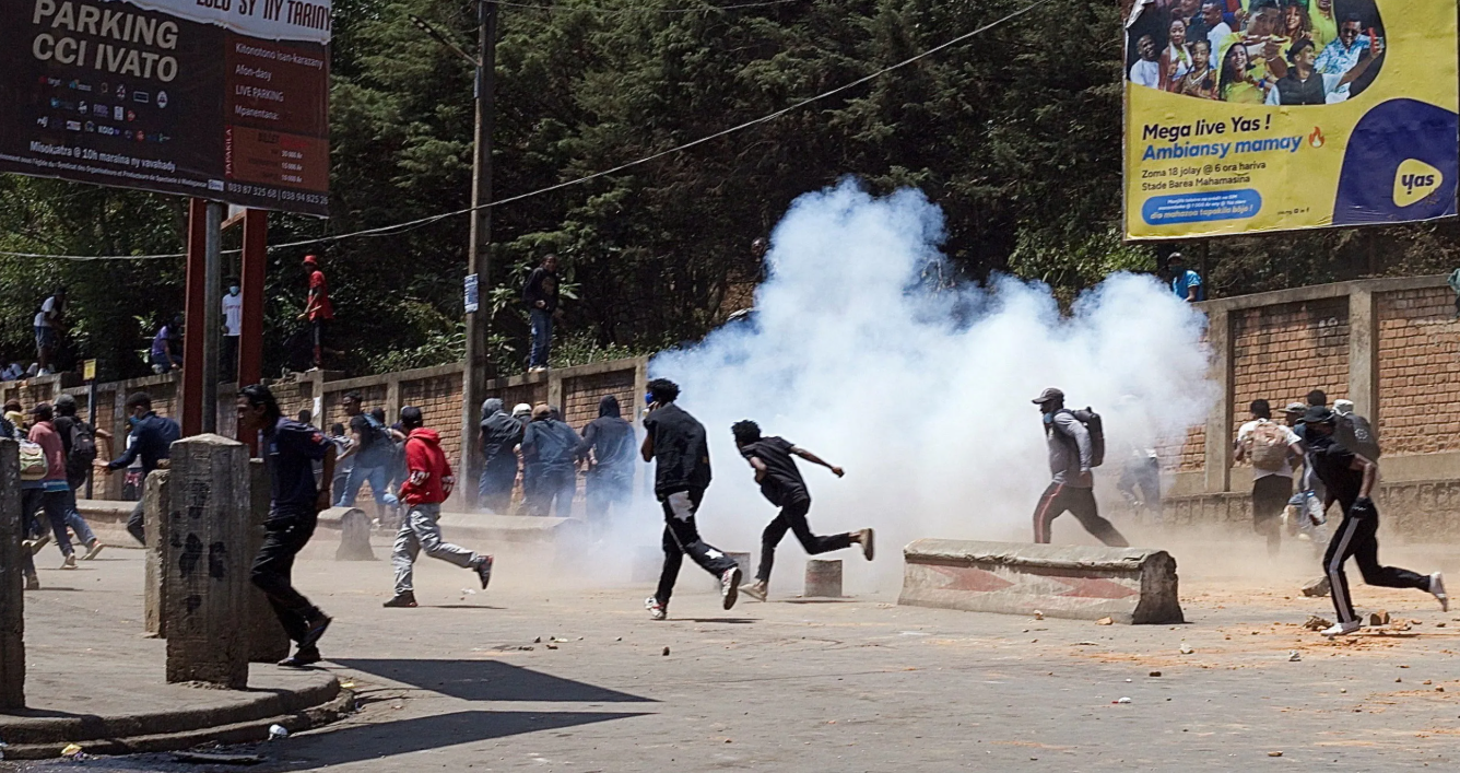 Riot police use tear gas to disperse protesters during a demonstration against frequent power outages and water shortages, near the University of Antananarivo, Madagascar
