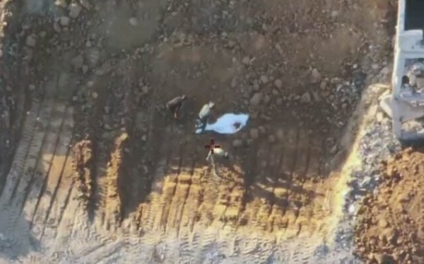 Hamas operatives are seen staging the recovery of the remains of a hostage in Gaza City, October 27, 2025.