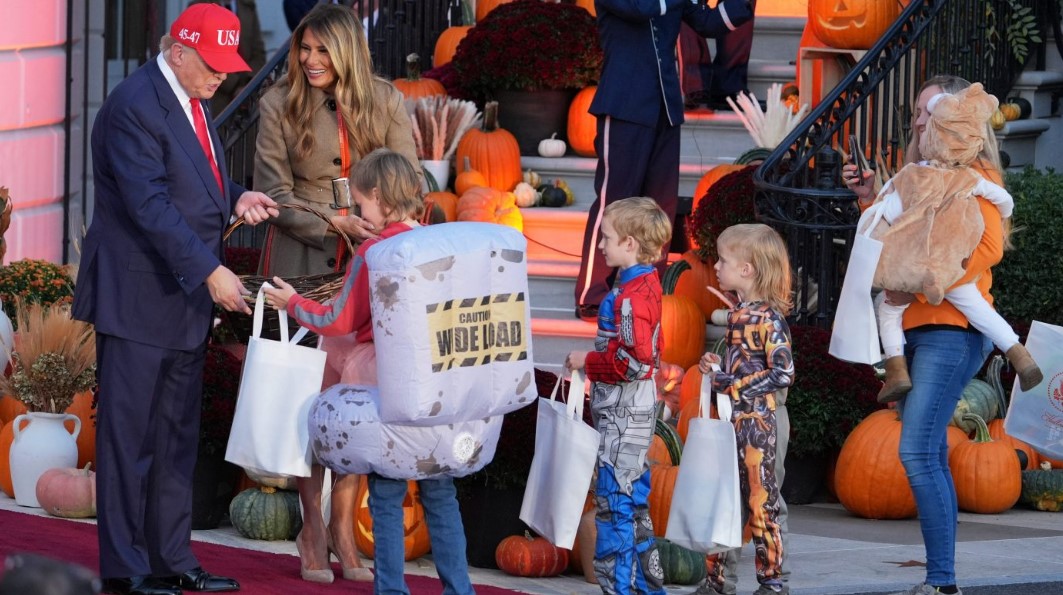 President Trump, from left, and first lady Melania Trump greet families and hand out candy during a Halloween event on the South Lawn of the White House, Oct. 30, 2025, in Washington.