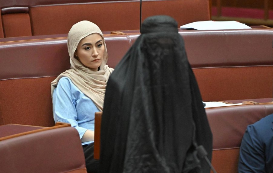 Independent senator Fatima Payman reacts as One Nation leader Pauline Hanson wears a burqa in the Senate chamber at Parliament House in Canberra, Australia, on November 24, 2025