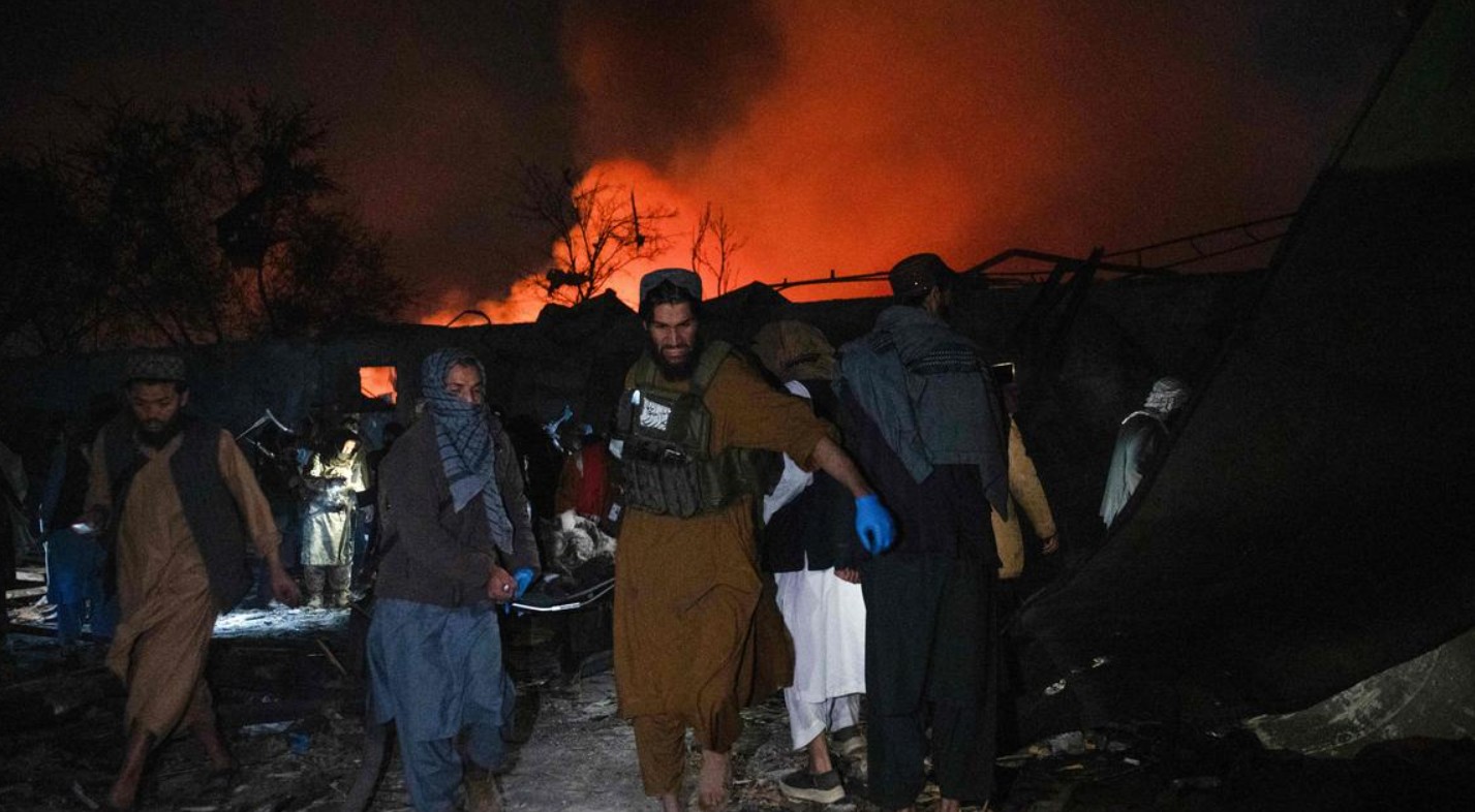 Taliban security personnel carry a body at the site of a damaged building after Pakistani airstrikes allegedly hit the Secondary Rehabilitation Services Centre in Kabul on March 16, 2026.